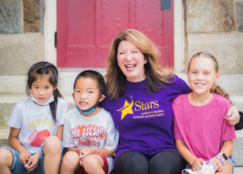 Atlantic Afterschool program teacher with 3 students